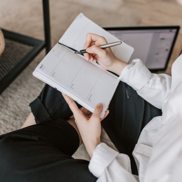 woman writing in planner